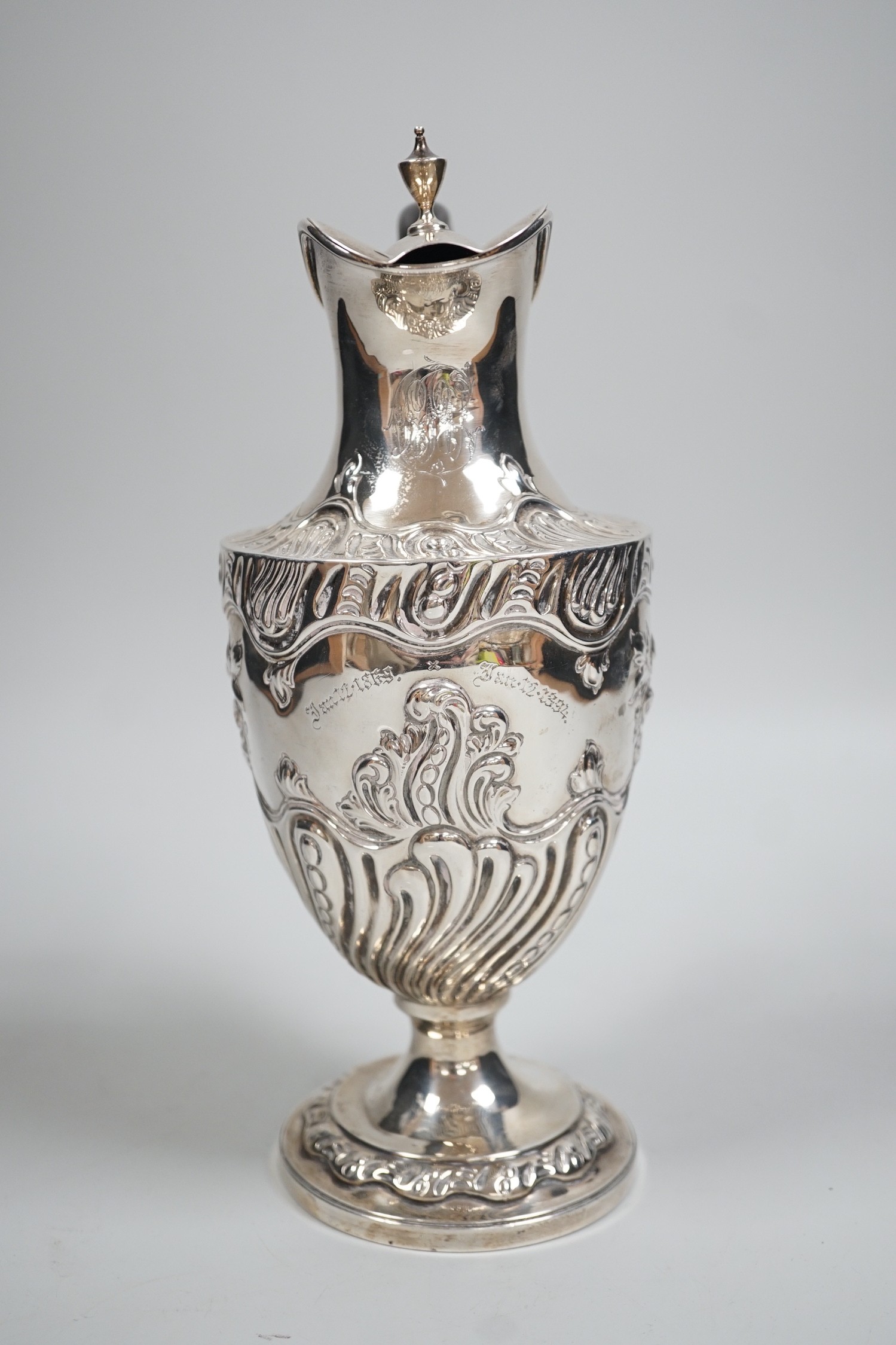 A late Victorian repousse silver pedestal hot water jug, Charles Stuart Harris, London, 1893, height 25cm, gross weight 13.3oz.